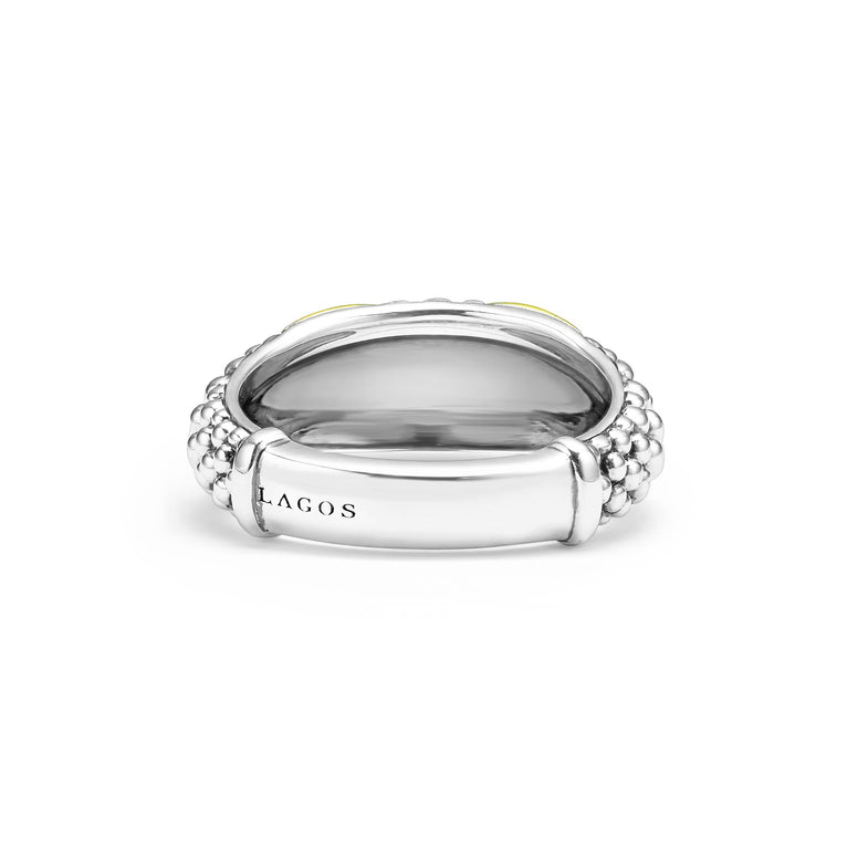 A back-view of a Sterling Silver & 18K Gold ring in the middle of a white background, featuring an x motif and caviar beading