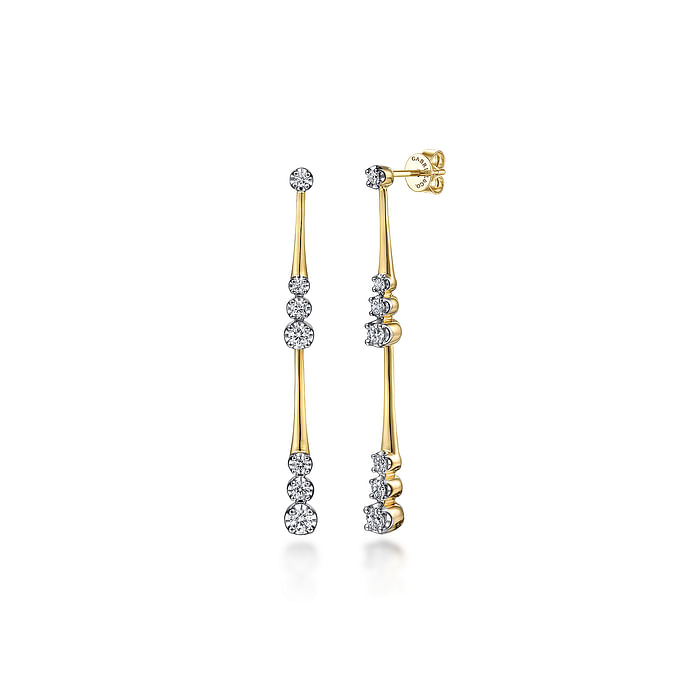 A pair of drop earrings with 14k yellow gold linear diamond stations and diamond clusters. 