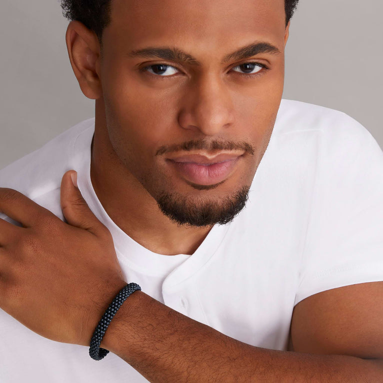 A man is wearing sterling silver beaded bracelet, featuring Matte black ceramic caviar beading