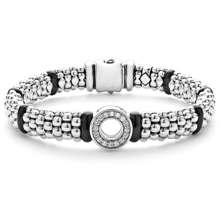 A sterling silver bracelet in the middle of a white background featuring smooth black ceramic and diamonds in a circle motif with Caviar beading 