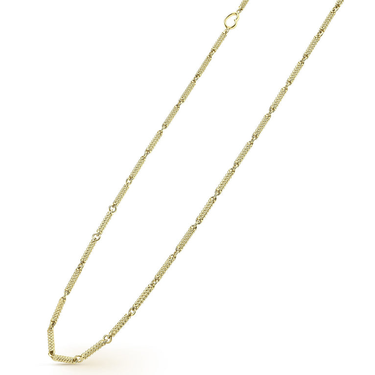 A close-up of an 18k gold necklace angled to the right, featuring caviar beading and a toggle clasp.n against a white background.