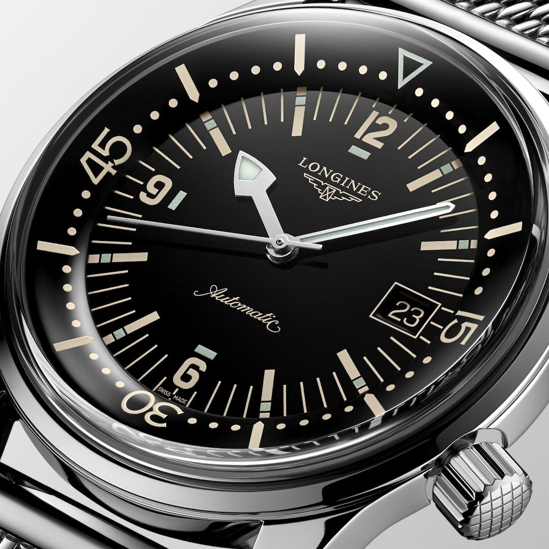 A close-up of a Longines watch highlighting the black dial and crown. 