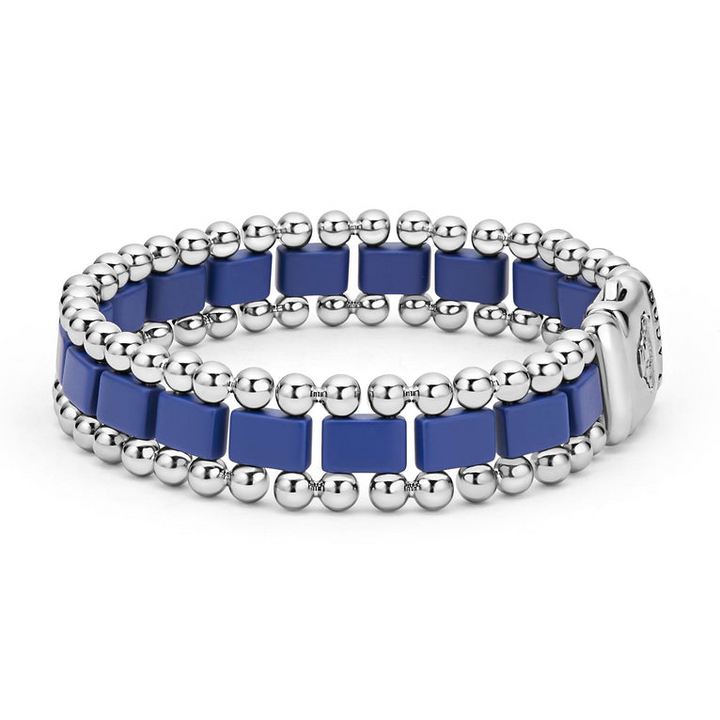 A side-view of a stainless steel bracelet in the middle of a white background featuring matte ultramarine ceramic and caviar beading.