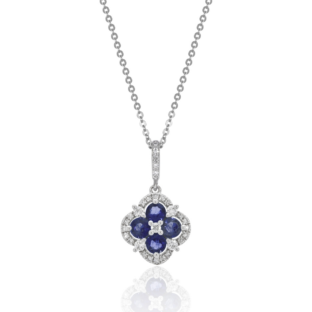 A close-up of a white-gold Halo Clover Necklace against a white background. The necklace features a clover motif pendant with sapphire round diamonds, milgrain detailing, and a 14k white gold chain.