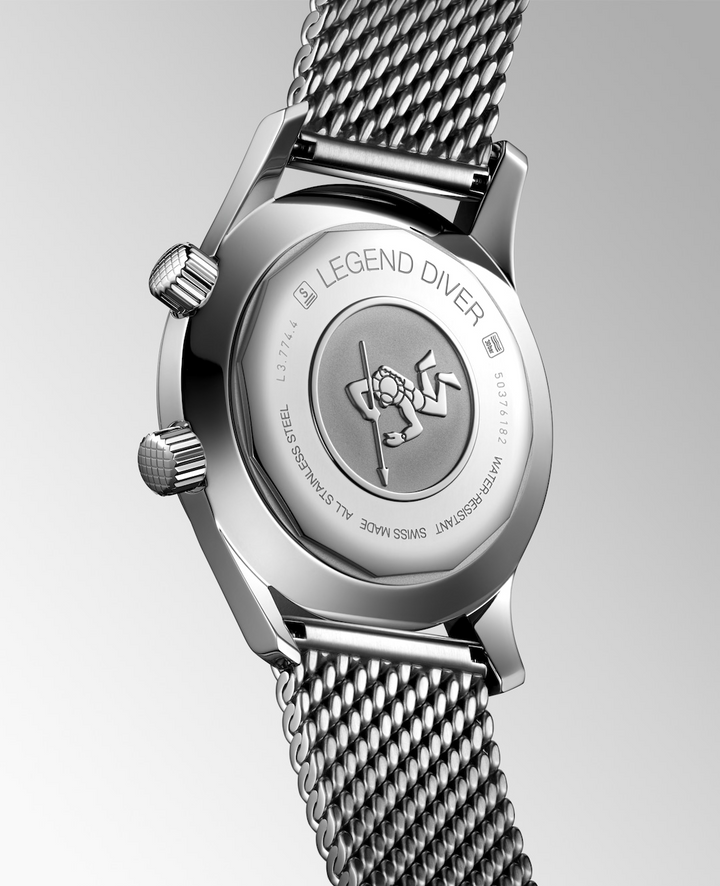 The back of a Longines watch is angled to the right, highlighting the case with a scuba driver engraved on the back and bracelet details. 