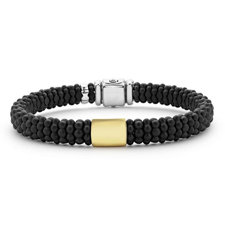 A sterling silver beaded bracelet in the middle of a white background, featuring Matte black ceramic caviar beading and a gold single station