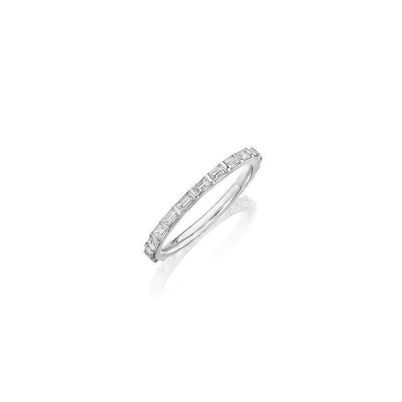 This is a close-up of a white gold ring angled to the left. It shows the inside of the band against a white background. It features a diamond set band with baguette detailing.