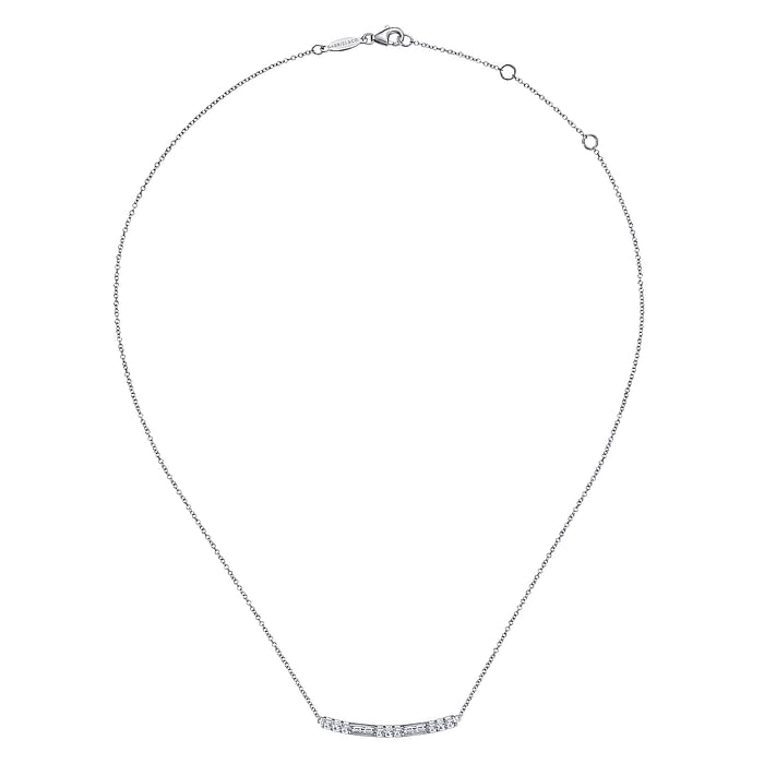 A white-gold Round and Baguette Diamond Curved Bar Necklace in the middle of a white background. The necklace features a curved bar encrusted with diamonds.