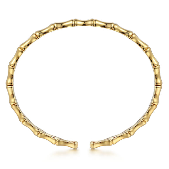 Front view of the yellow gold bar station bangle showing its oval shape and sculpted bamboo-style segments
