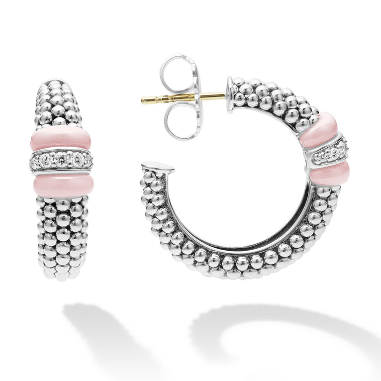 A pair of hoop earrings with pink ceramic and a diamond station with sterling silver Caviar beads. The right earring is angled to the side, showing the back.