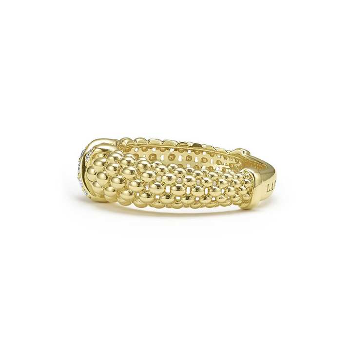 A side-view of a 18K gold diamond-set x-motif ring with caviar beading