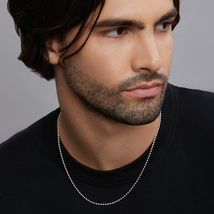 A man wearing a sterling silver featuring a ball chain.