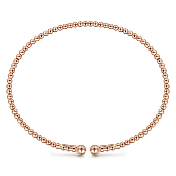 Front view of the Bujukan rose gold split bangle showing its oval shape and open ball ends