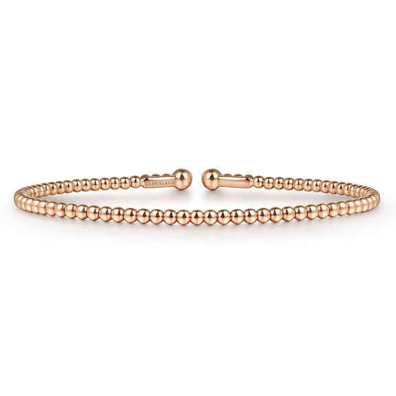 Low side view of the Bujukan rose gold split bangle showing its beaded band and engraved Gabriel & Co name