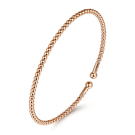 Gabriel & Co Bujukan 14K rose gold split bangle shown at an angle with polished beads and ball ends