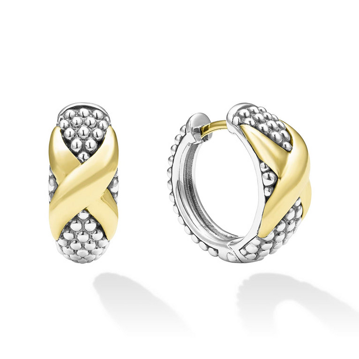 A pair of two-tone huggie earrings with Smooth 18k gold and sterling silver Caviar beading and an x motif. The right earring is angled to the side.