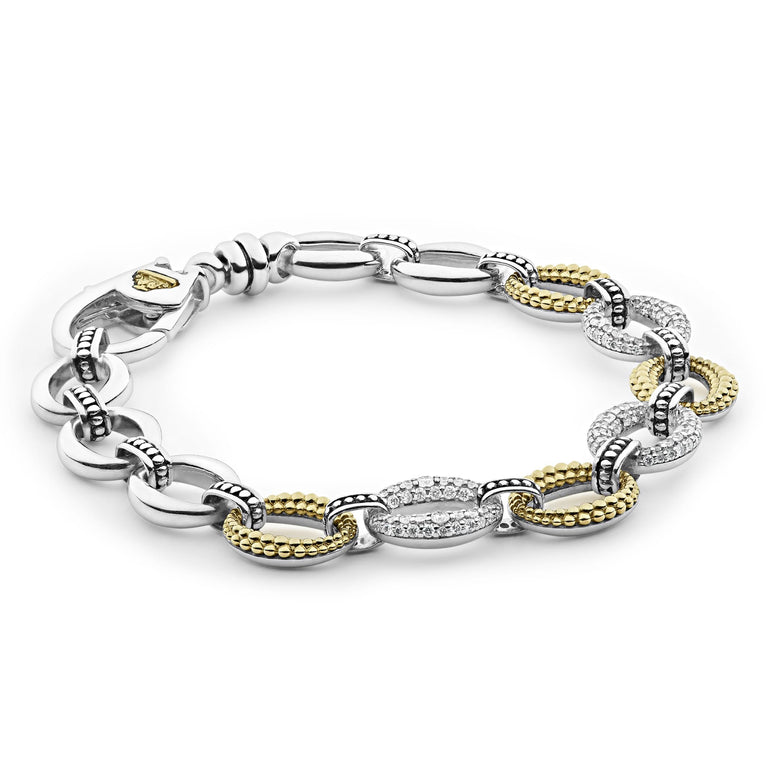 A Sterling Silver & 18k gold bracelet angled resting in the middle of a white background. The bracelet has pave diamond links and a signature lobster clasp. 