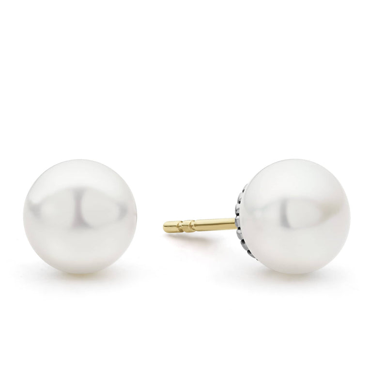 A pair of stud earrings with a cultured freshwater pearl framed by flutes of sterling silver. The right earring is angled to the right.