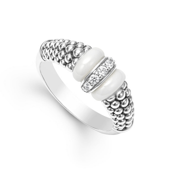 A sterling silver ring is displayed angled on a white background featuring white ceramic caviar beading with a row of diamonds.