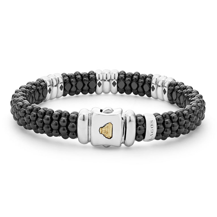 A sterling silver bracelet in the middle of a white background highlight the clasp, featuring three diamond stations, black ceramic caviar beading, and sterling silver stations