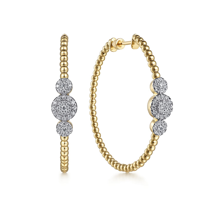 Diamond hoop earrings with circles of golden beads are crowned with a trio of diamond circles