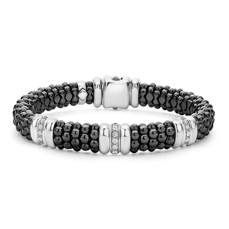 A sterling silver bracelet in the middle of a white background featuring three diamond stations, black ceramic caviar beading, and sterling silver stations