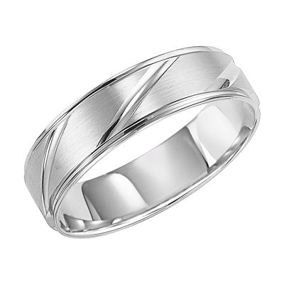 An angled view of a platinum wedding band against a white background. The ring features angular carvings.