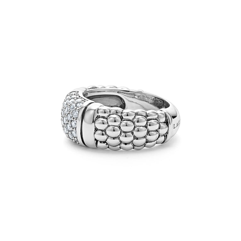 A side view of a white gold diamond ring against a white background. The ring features Pavé diamonds and sterling silver Caviar beading with sterling silver stations in between the diamonds and beading.