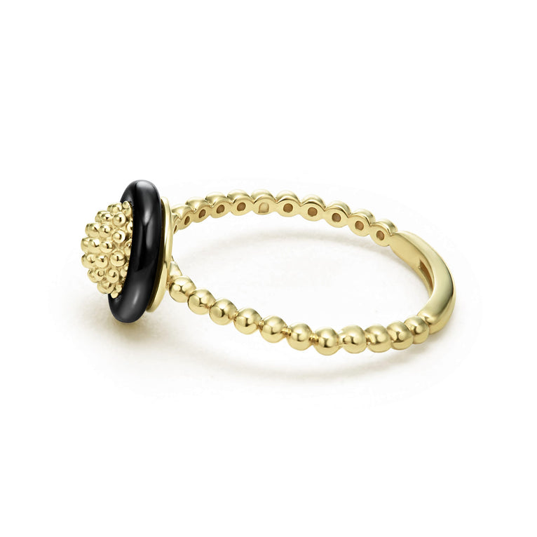 A side-view of An 18K Gold ring in the middle of a white background featuring caviar beading framed by black ceramic