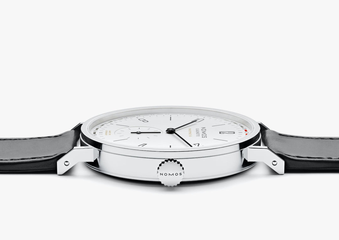 A Nomo Glashutte watch is lying flat and showcasing the dial.