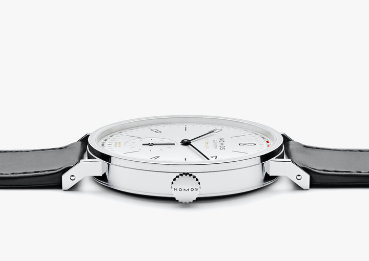 A Nomo Glashutte watch is lying flat and showcasing the dial.