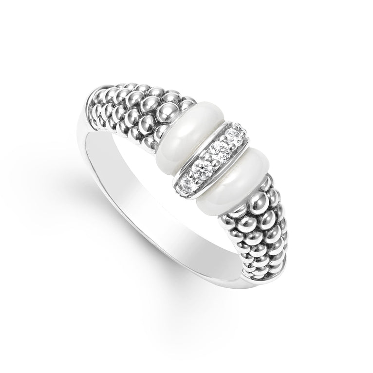 An angled view of a white gold diamond ring against a white background. The ring features round-shaped diamonds set in sterling silver, accented by sleek white ceramic and Caviar beading around the band. 