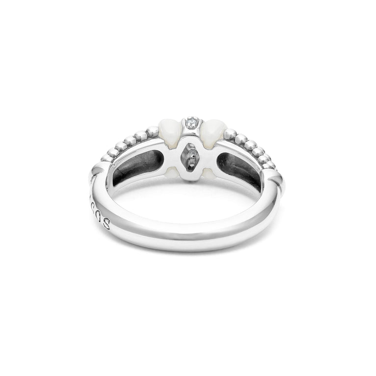 A back view of a white gold diamond ring against a white background. The ring features round-shaped diamonds set in sterling silver, accented by sleek white ceramic and Caviar beading around the band. 