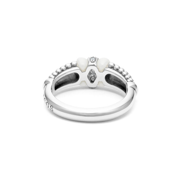 A back view of a white gold diamond ring against a white background. The ring features round-shaped diamonds set in sterling silver, accented by sleek white ceramic and Caviar beading around the band. 