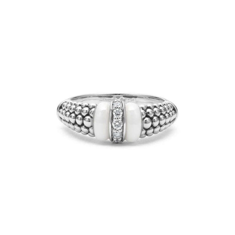 A front view of a white gold diamond ring against a white background. The ring features round-shaped diamonds set in sterling silver, accented by sleek white ceramic and Caviar beading around the band. 