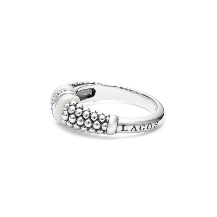 A side view of a white gold diamond ring against a white background. The ring features round-shaped diamonds set in sterling silver, accented by sleek white ceramic and Caviar beading around the band. 