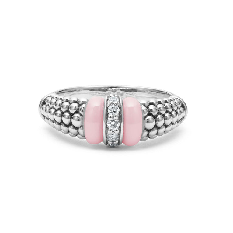 A front view of a white gold diamond ring against a white background. The ring features round-shaped diamonds set in sterling silver, accented by sleek light pink ceramic and Caviar beading around the band. 