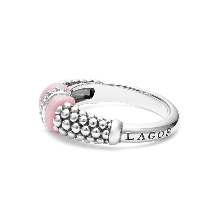 A side view of a white gold diamond ring against a white background. The ring features round-shaped diamonds set in sterling silver, accented by sleek light pink ceramic and Caviar beading around the band. 