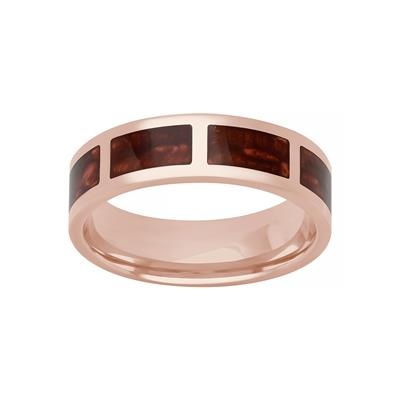 A tilted front view of a rose gold wedding band against a white background. The ring features a flat ladder design highlighted by a bold red ceramic inlay.