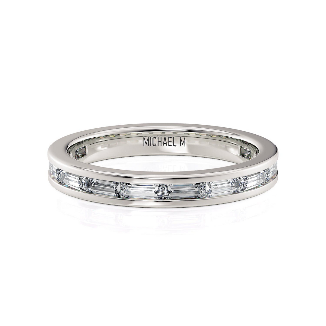 A front view of a white gold wedding band against a white background. The ring features a 3/4 eternity style with channel-set princess cut diamonds.