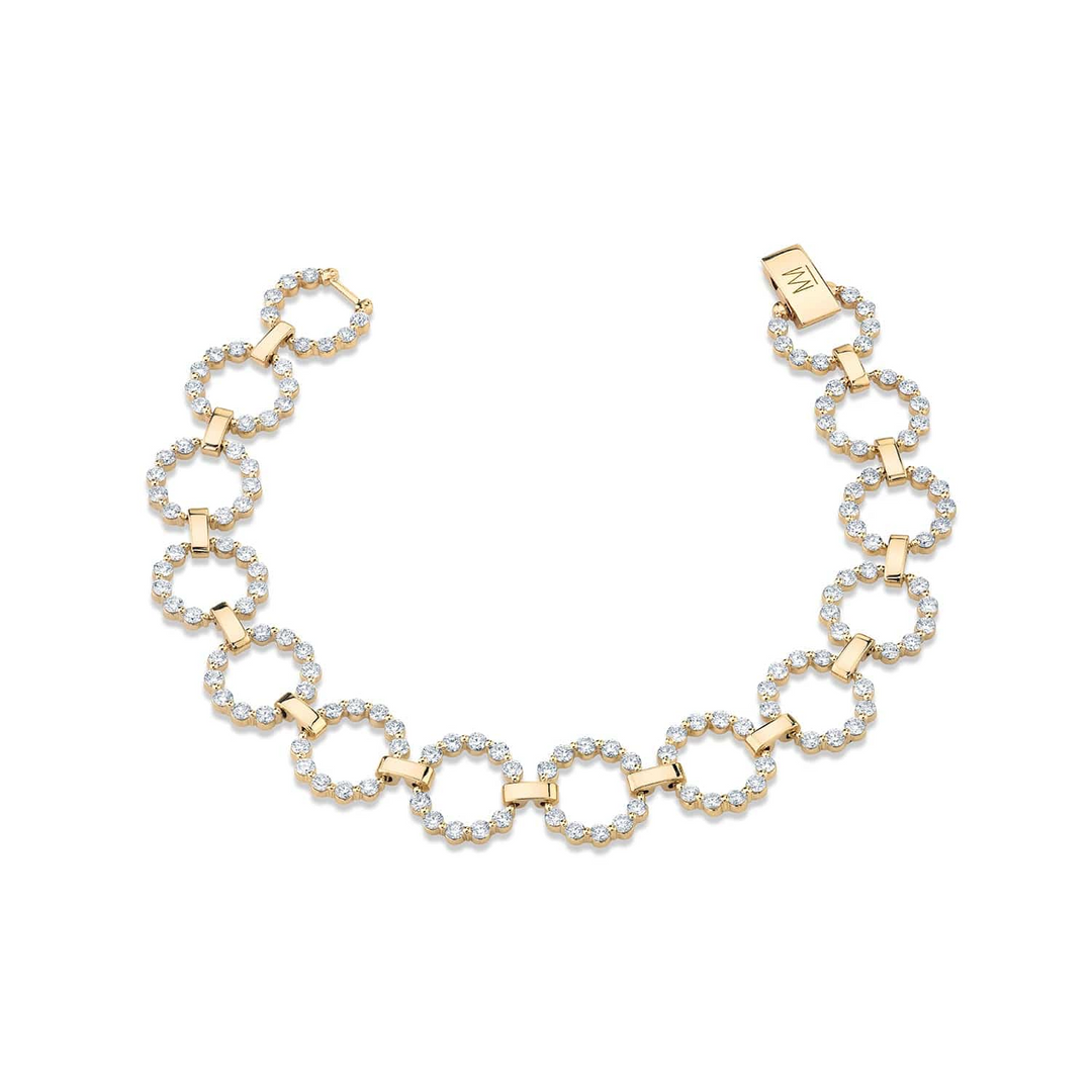 A front view of a diamond bracelet against a white background. The ring features a diamond ring with yellow gold signature shared prongs.