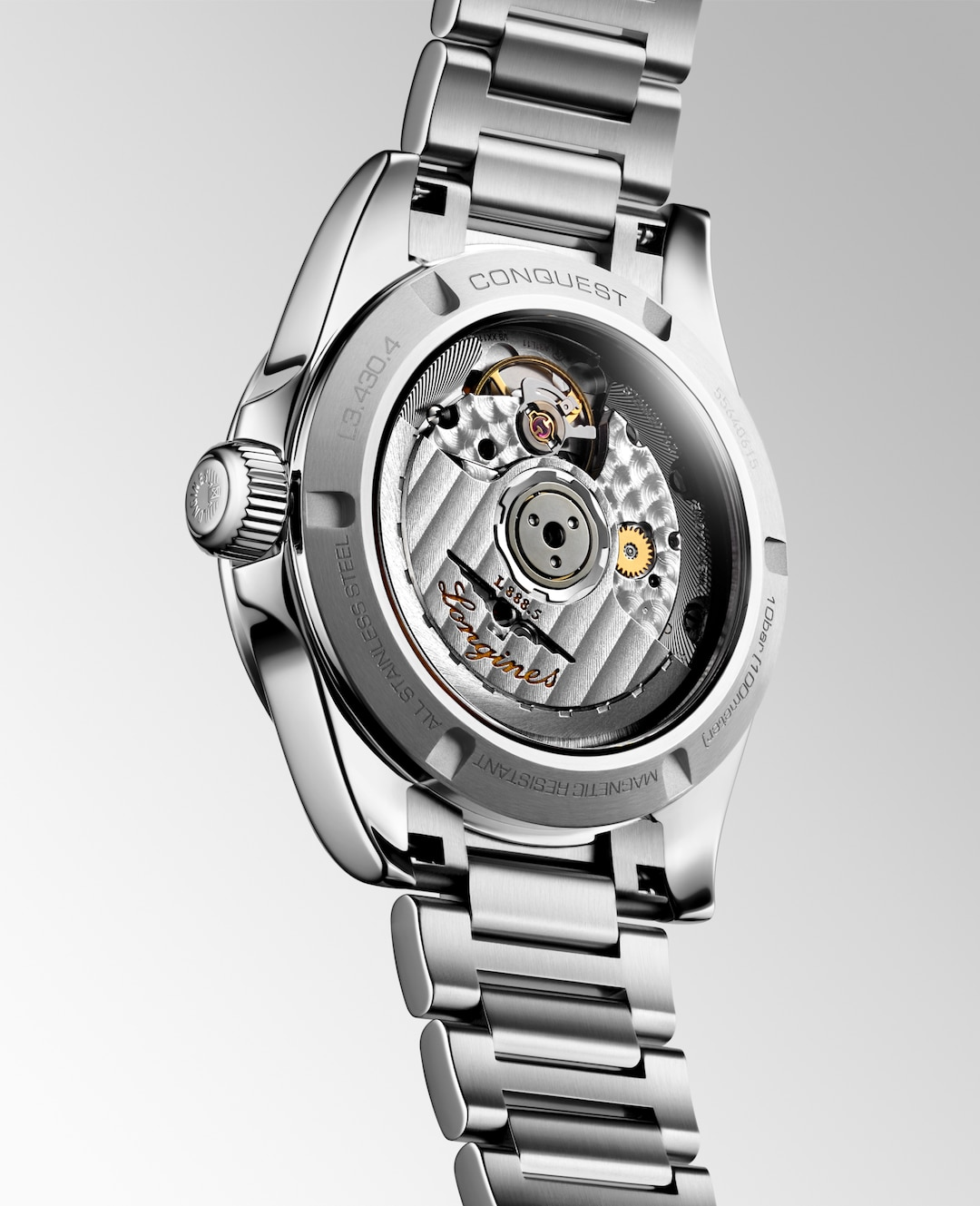 Close up view of the back of a LONGINES Conquest with a stainless-steel bracelet.