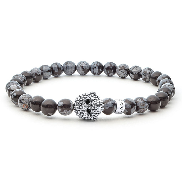 A sterling silver bracelet is displayed in the middle of a white background featuring a Snowflake obsidian gemstone beaded bracelet with a sterling silver Caviar skull.