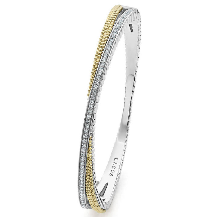 A Sterling Silver and 18k gold bangle bracelet angled to the side and displayed on a white background. The bracelet has caviar beading with an X design.