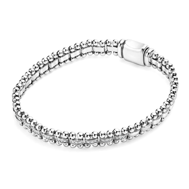 A sterling silver link bracelet angled in the middle of a white background featuring diamonds framed by sterling silver Caviar beading