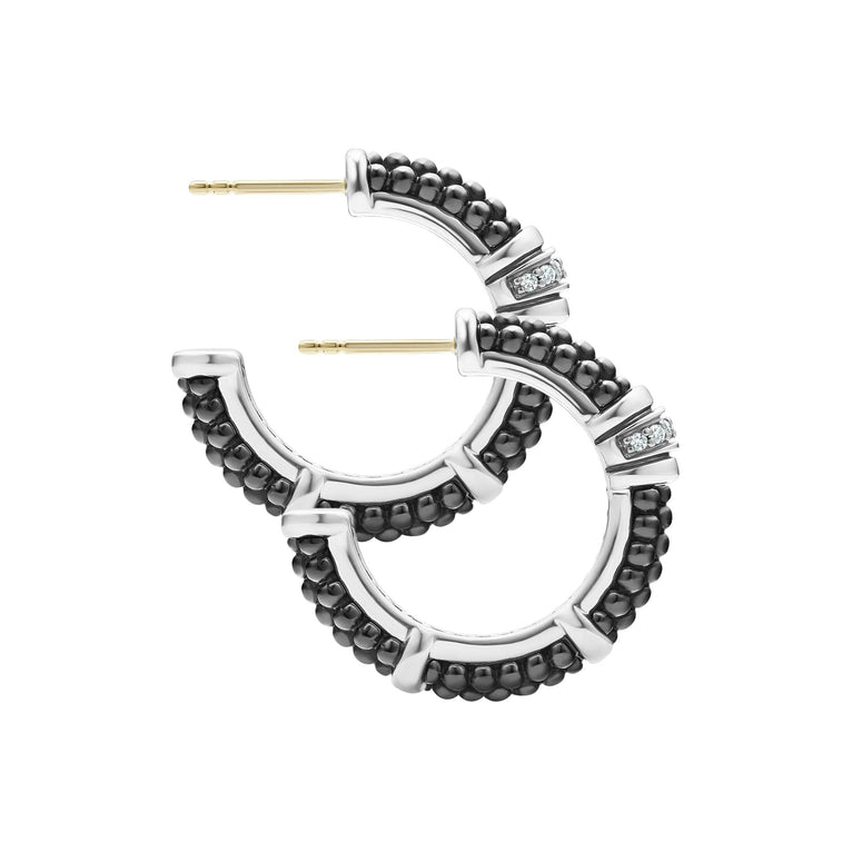 A pair of hoop earrings with Black ceramic Caviar beading, sterling silver, and diamonds.  Both earrings are angled to the side.