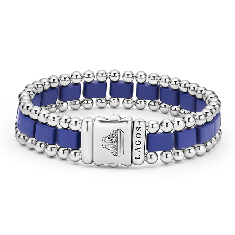 A stainless steel bracelet standing vertically in the middle of a white background featuring matte ultramarine ceramic and caviar beading.