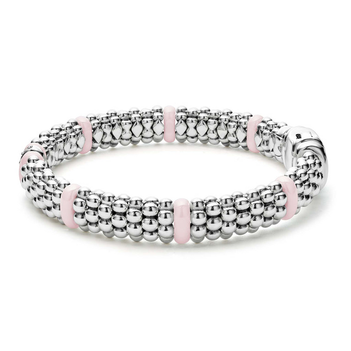 A side-view of a sterling silver & 18k gold bracelet displayed in the middle of a white background, featuring pink ceramic and Caviar beading.