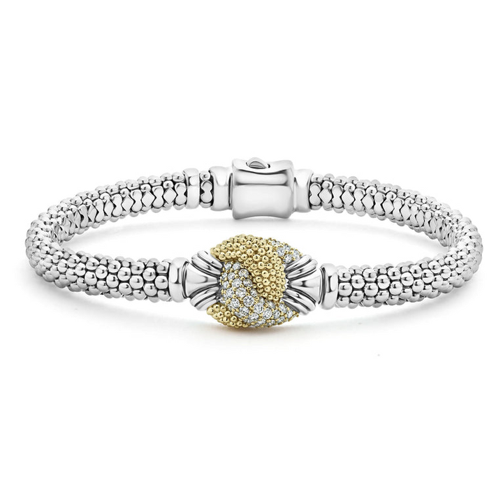 A Sterling Silver & 18k gold bracelet resting in the middle of a white background. The bracelet features diamonds and gold women in a knot motif.