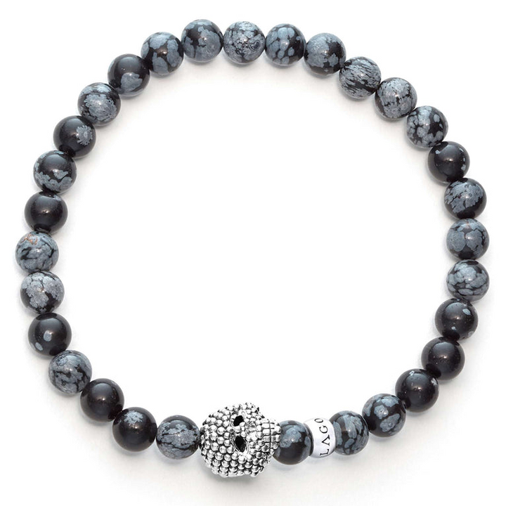 A sterling silver bracelet is displayed in the middle of a white background featuring a Snowflake obsidian gemstone beaded bracelet with a sterling silver Caviar skull.